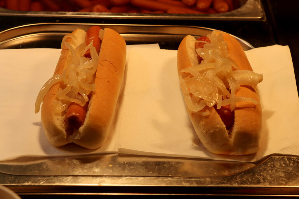 Picture of hot dogs, covered in onions