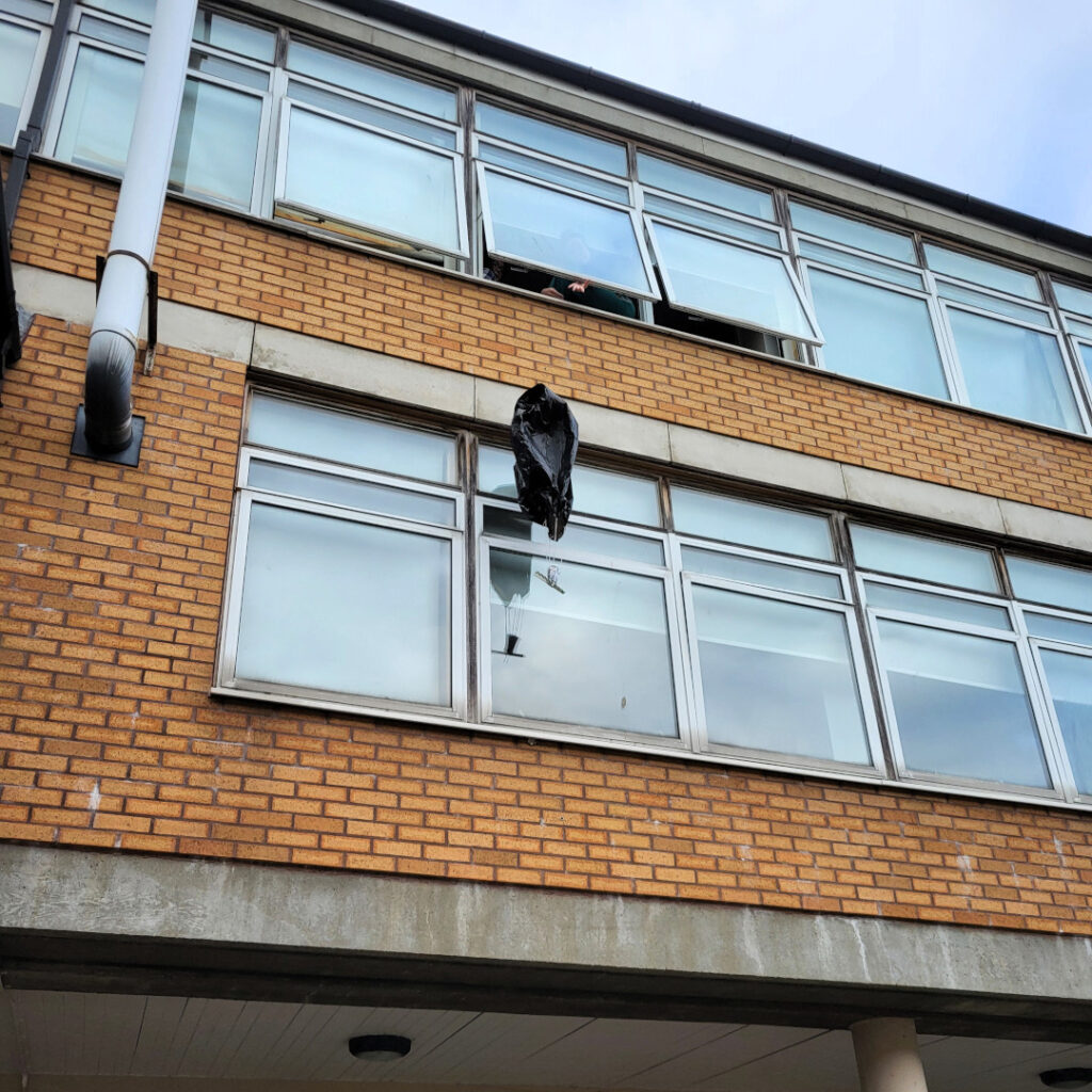 Egg being parachuted to the group using a science experiment.