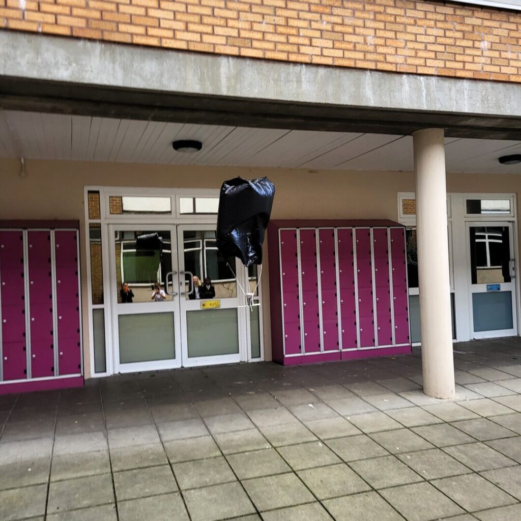 Egg being parachuted to the group using a science experiment.