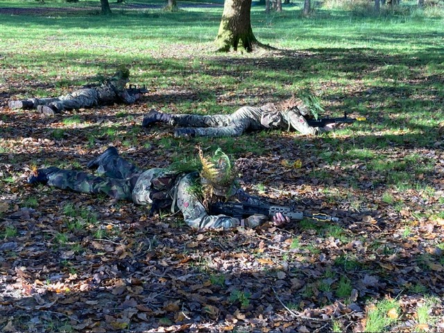 Students with rifles in a prone position