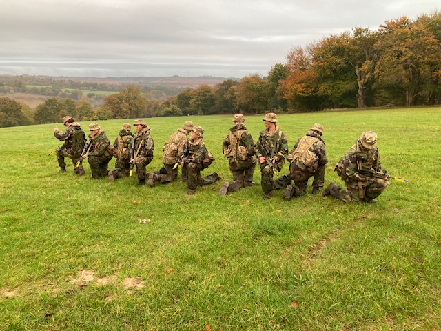 Students lined up on their knees posing for the picture