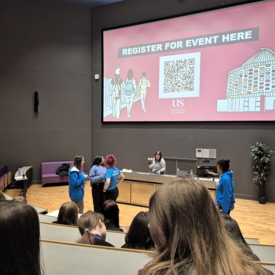 In the seminar hall at University of Sussex, students are sitting Infront of the University representatives that are conducting the program.