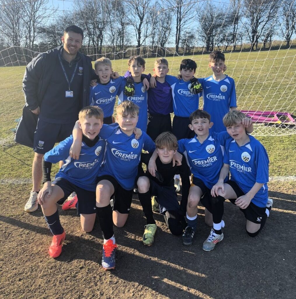 Year 7 Football Team 2025 posing for a team photo with Mr Ford