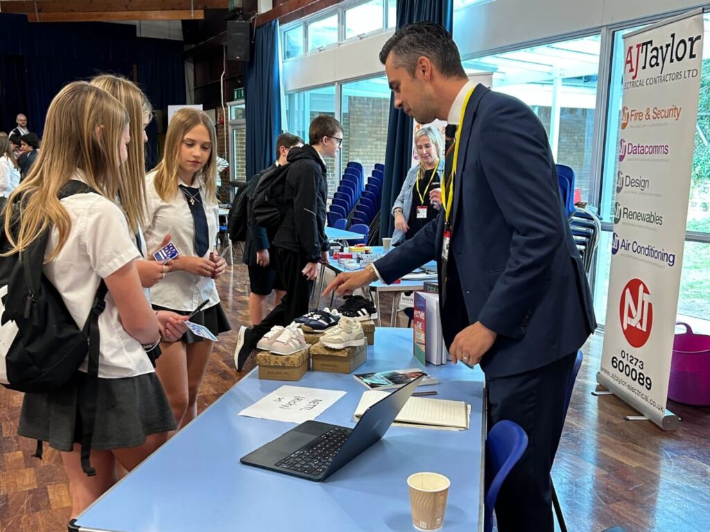 Students at Longhill's Career's Fair 2025, speaking to representatives in the Main School Hall.