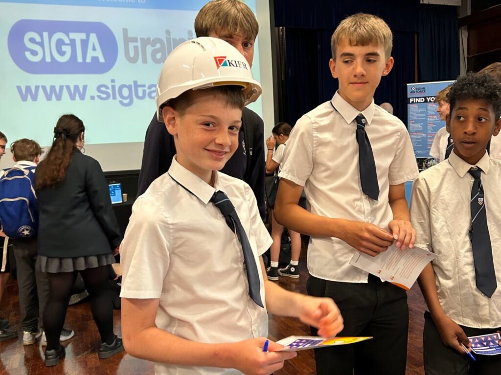 Students at Longhill's Career's Fair 2025, with one student wearing a Kier hat participating in the game.
