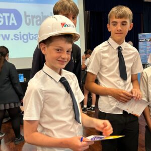 Students at Longhill's Career's Fair 2025, with one student wearing a Kier hat participating in the game.