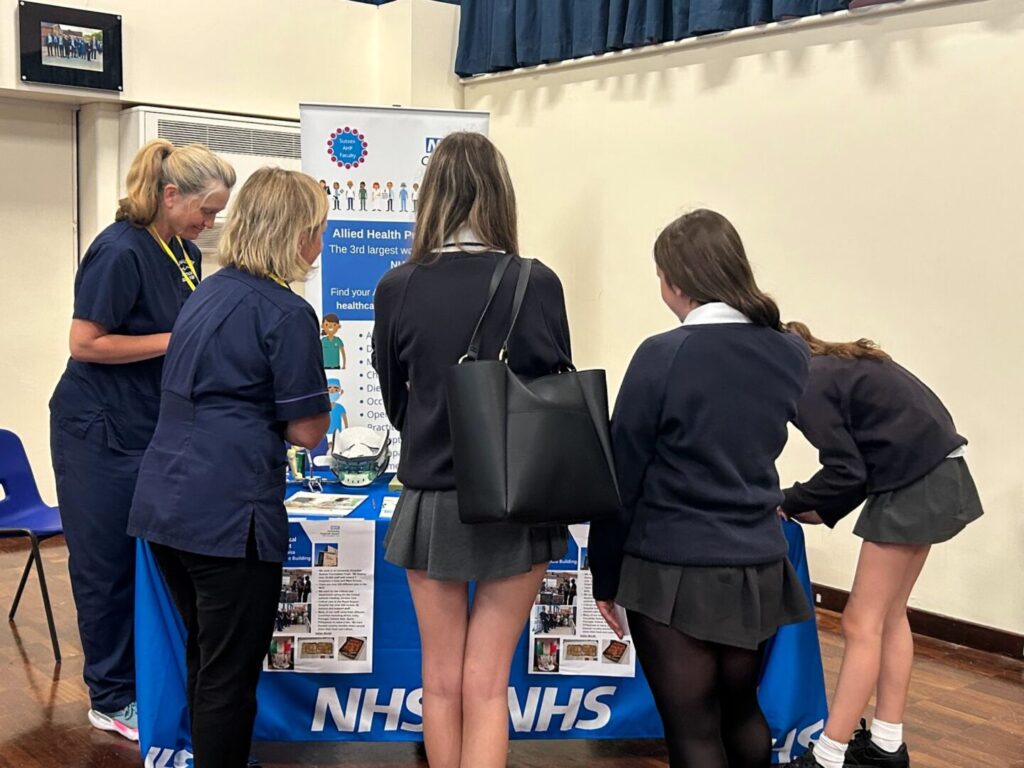 Students at Longhill's Career's Fair 2025, at the NHS Careers stand speaking to representatives