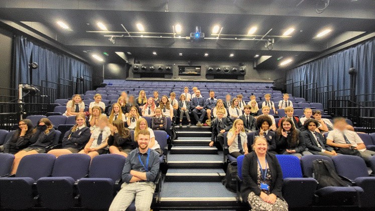 Group photograph of students and teachers in a lecture hall in the University of Brighton