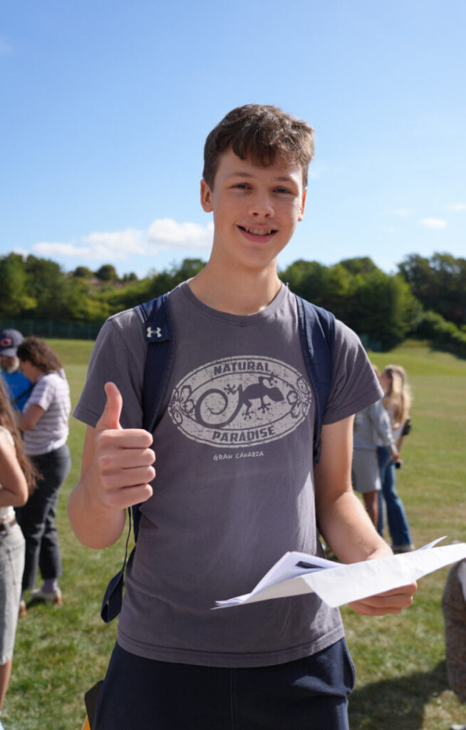 Student gives a thumbs up after seeing results