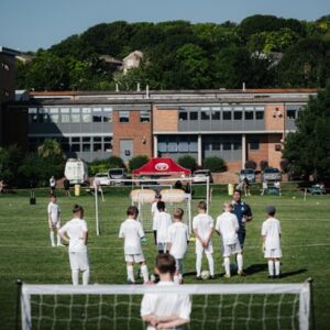 Image of students listening to the coach at the Real Madrid Football Clinic