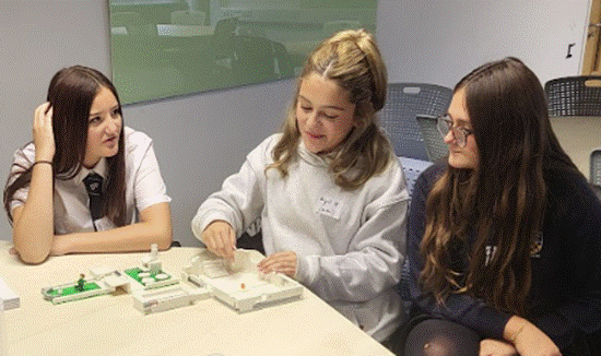 Group photo of students working on a practical task.
