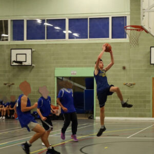 Student jumping up for a layup