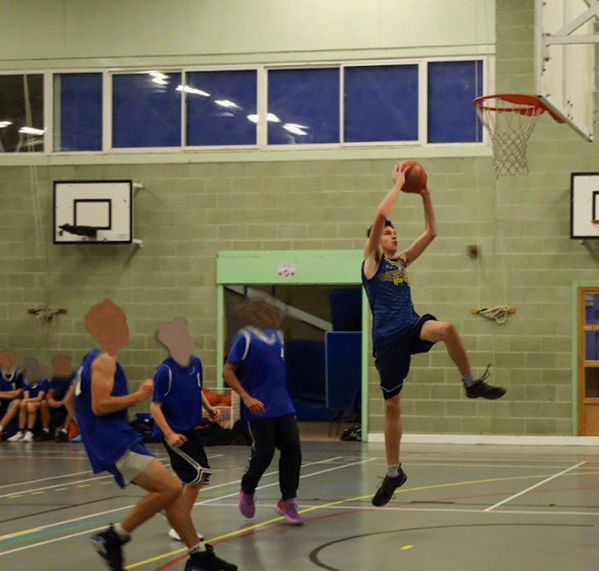 Student jumping up for a layup