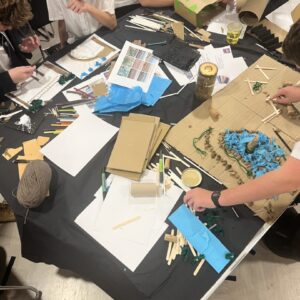 Students participating in the workshop at a table with their crafting tools