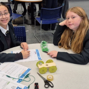 Students at a table posing for a photograph