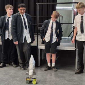 Students around their mechanical device