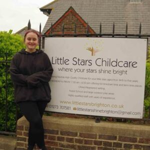 Student posing outside nursery