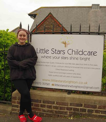 Student posing outside nursery