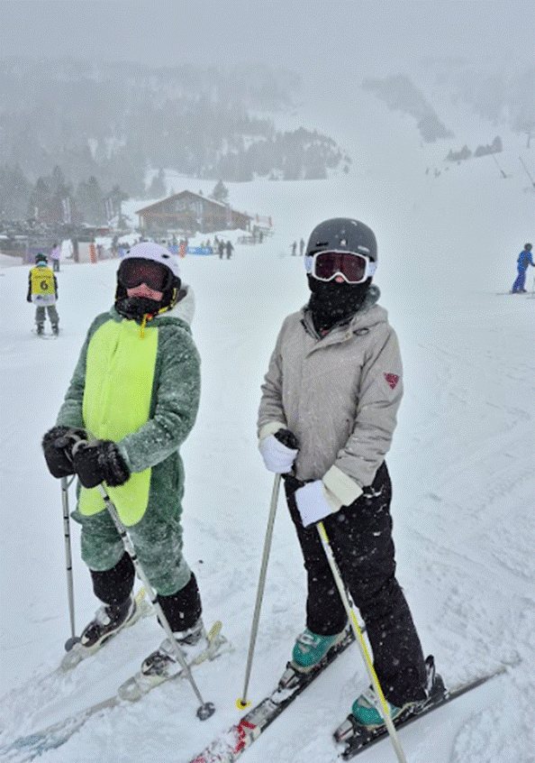 2 students posing for a photograph halfway down a slope
