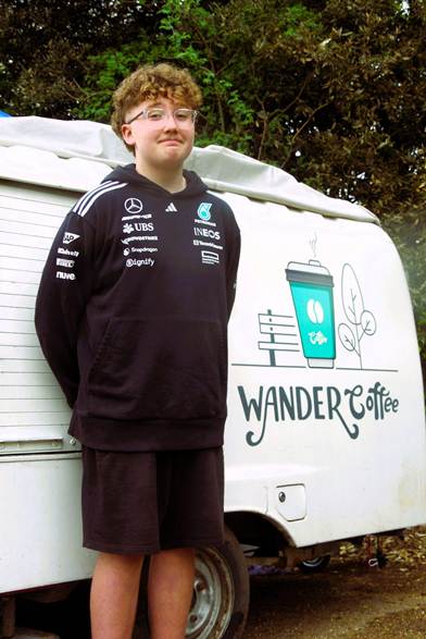 Student standing next to mobile coffee shop
