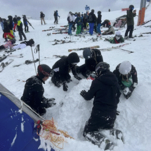 Group of students burying another student under the snow.