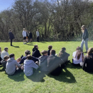 Students sitting on Longhill High School field