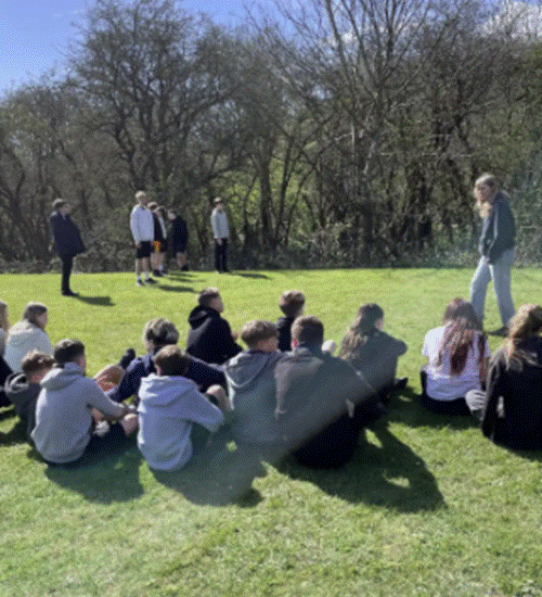 Students sitting on Longhill High School field