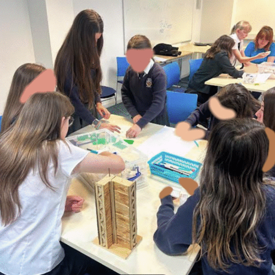 Students participating in workshop in a class room at the University of Brighton