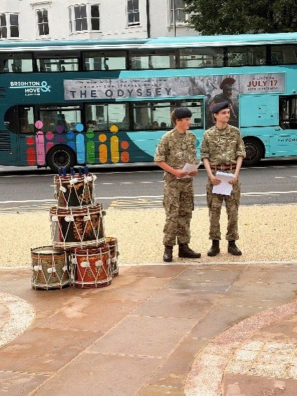 Longhill Cadets standing next to regimental drums.
