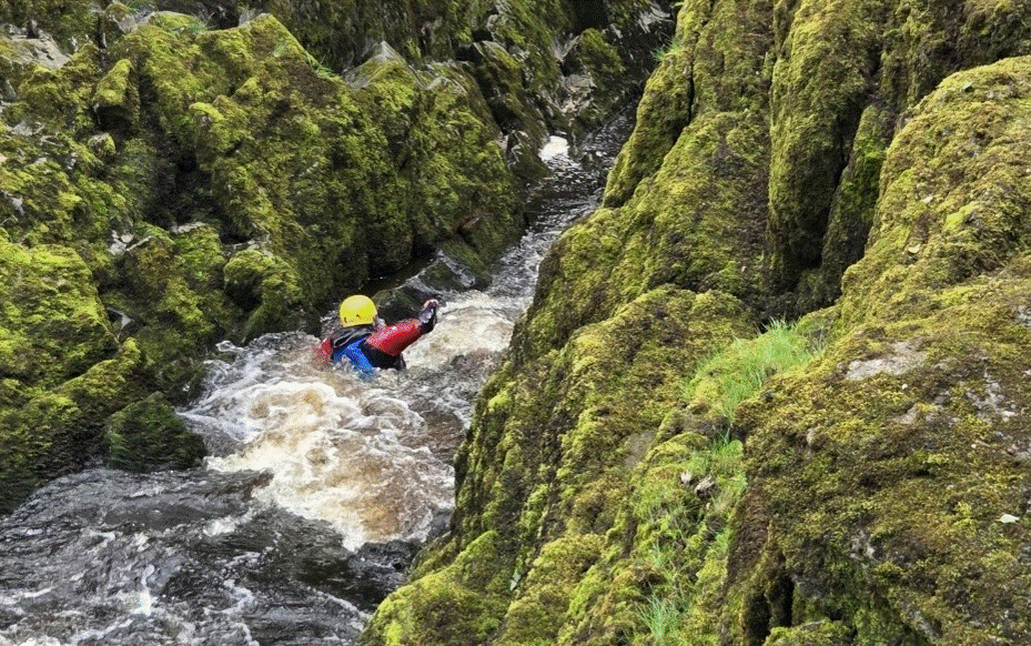 Cadet navigating their way through the river between the rocks