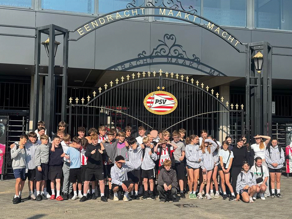Students posing outside of the PSV Eindhoven Football Stadium