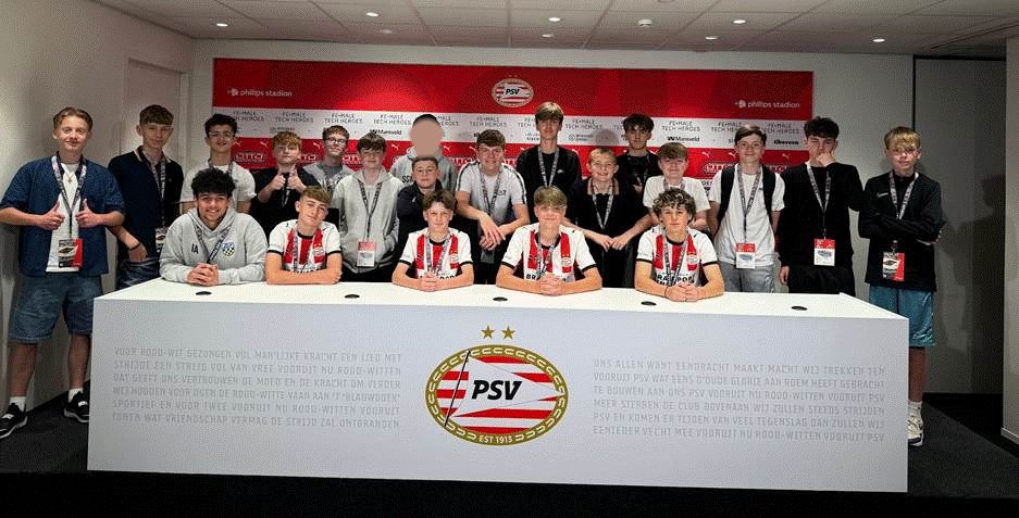 Students posing for a photo in the press room.