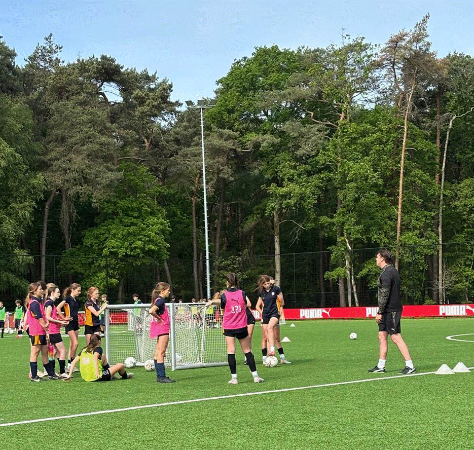 Students receiving coaching at the PSV Eindhoven training ground.
