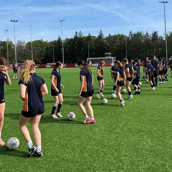 Students receiving coaching at the PSV Eindhoven training ground.