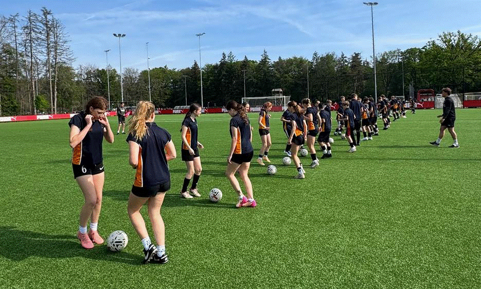 Students receiving coaching at the PSV Eindhoven training ground.