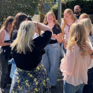 Students gathered together in a group discussing their results